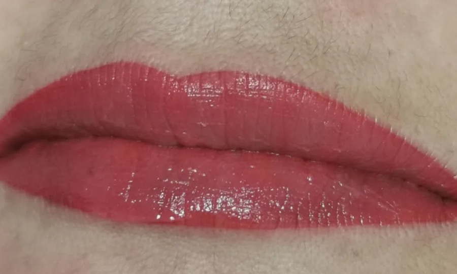 Lèvres redessinées en rouge au contour net après une bouche bisou
